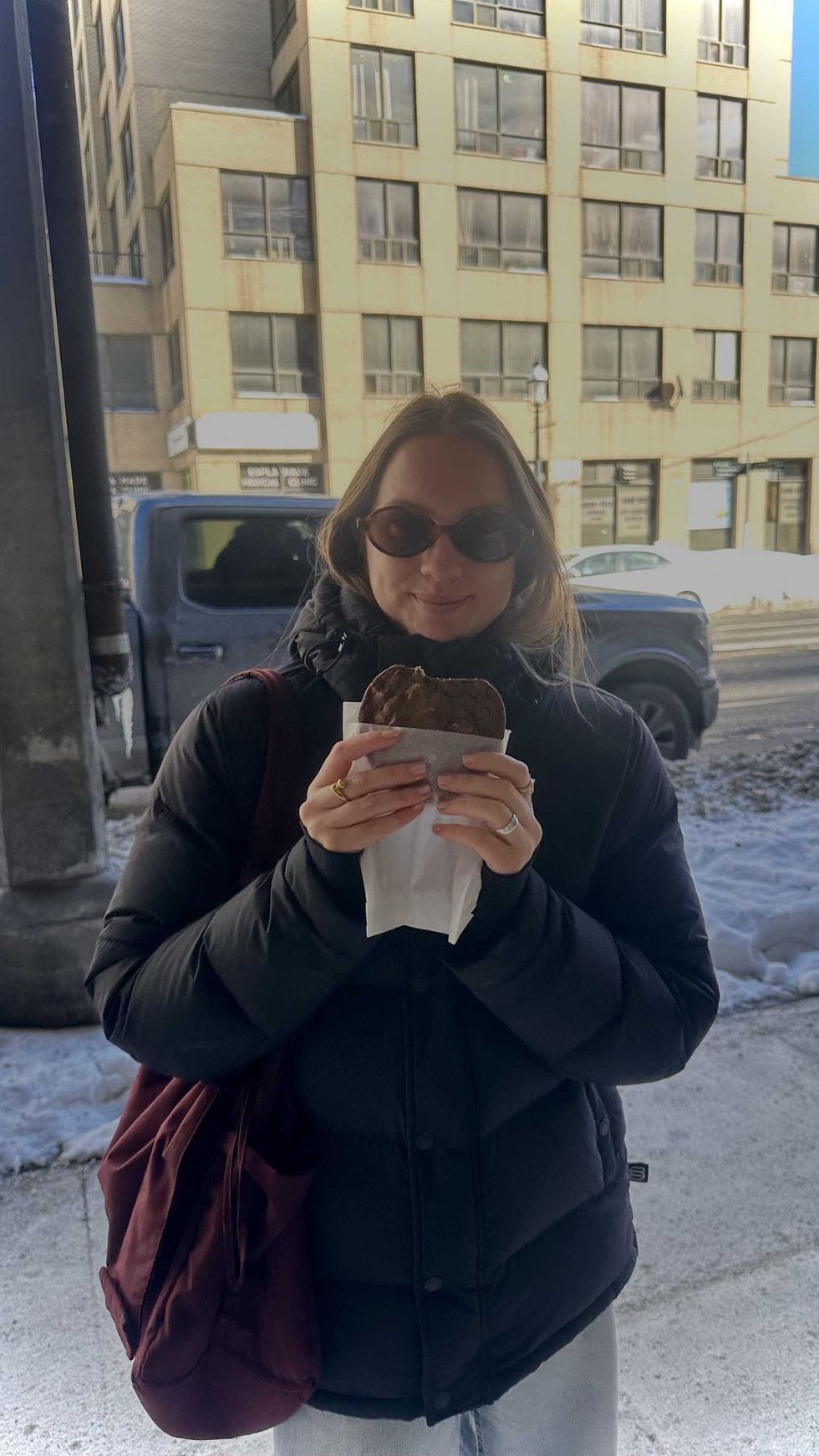 A person holding a cookie.