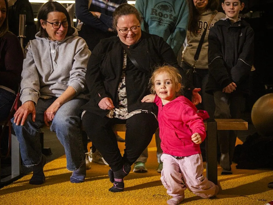 Two-year-old Hazel Newton mimicks Morgan McKay’s lunging movements on Saturday.