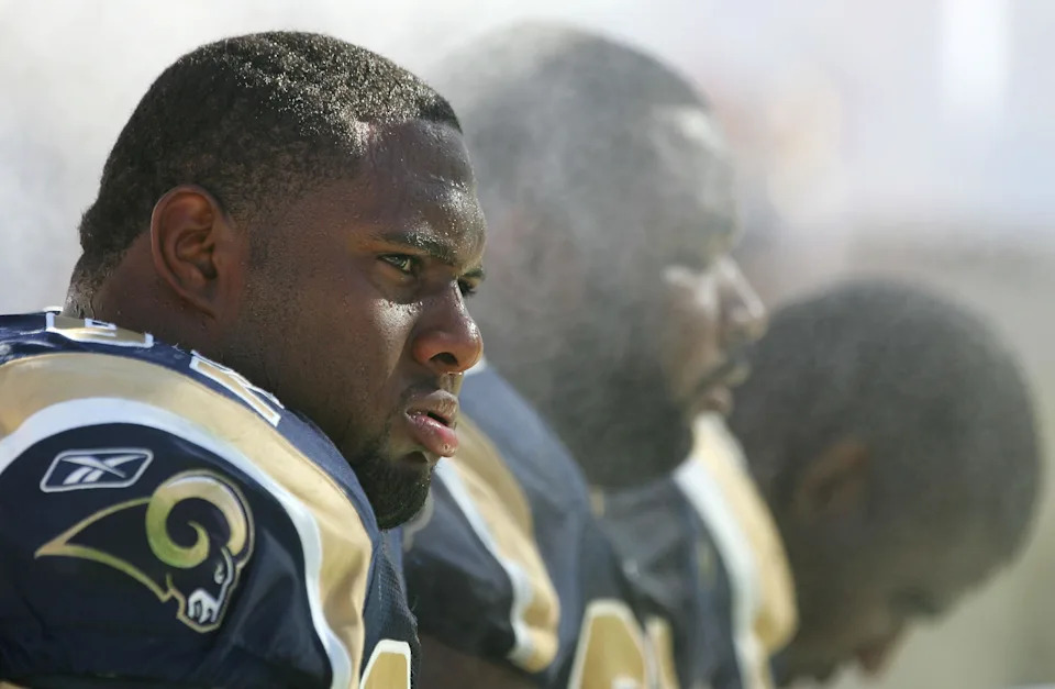 TEMPE, AZ - SEPTEMBER 18: (L-R) Defensive tackles Damione Lewis #92, Ryan Pickett #79 and Jimmy Kennedy #73 of the St. Louis Rams cool down on the bench under misting ventilators.