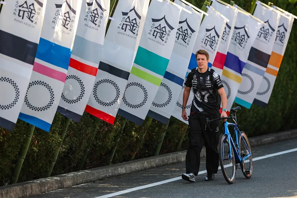 Frederik Vesti, Mercedes, walks in the paddock with his bicycle.