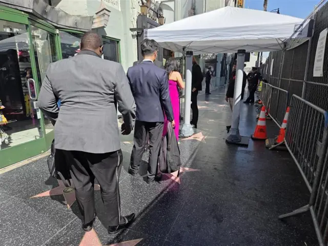 Journalists walk through security at the Oscars