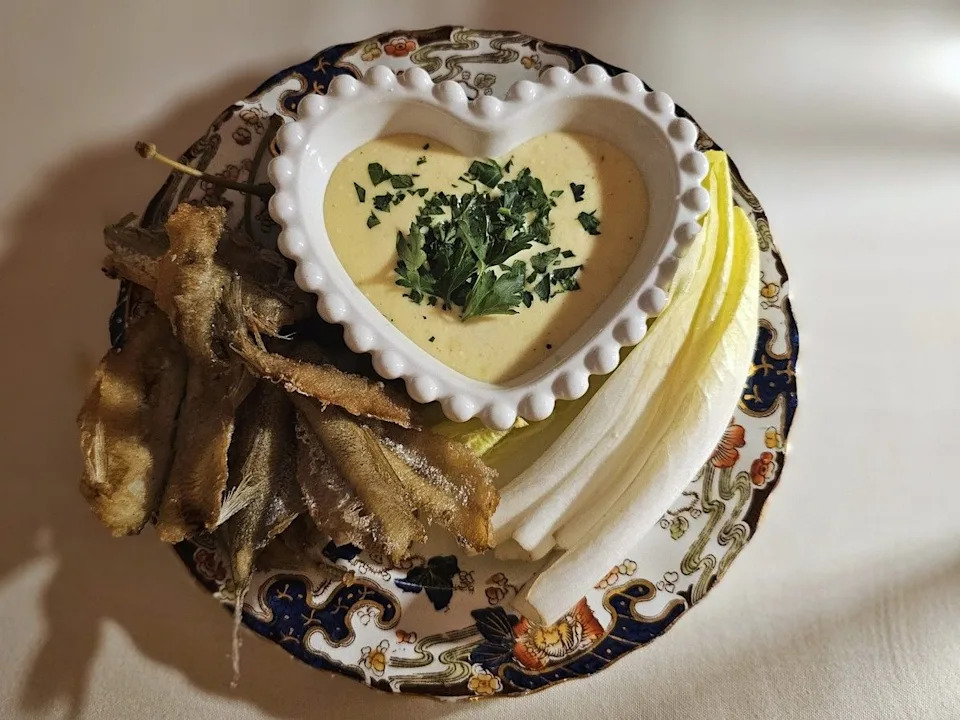 Fried smelt served with endive leaves meant to be used as a shell and lemon parmesan aioli for dipping.