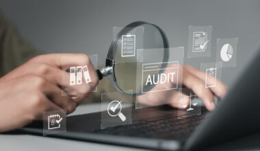 Businessman using laptop computer to audit and evaluate corporate financial statements for Audit business concept. Auditing financial accounts within the organization.