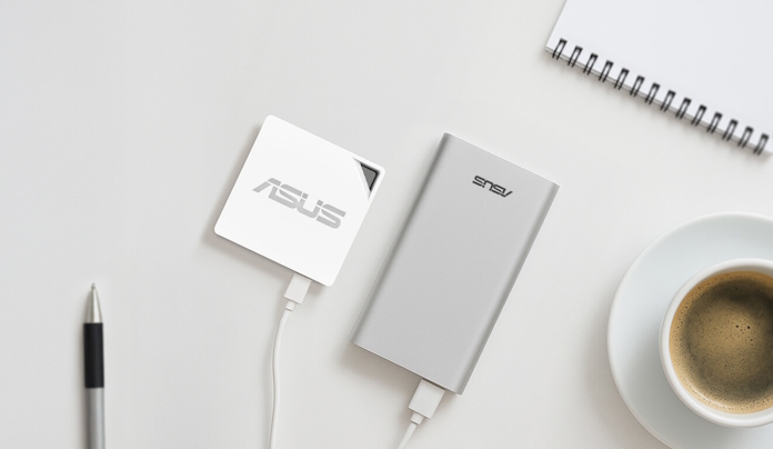 The ASUS AX50 Go mini router on a table with an ASUS power bank and a cup of coffee