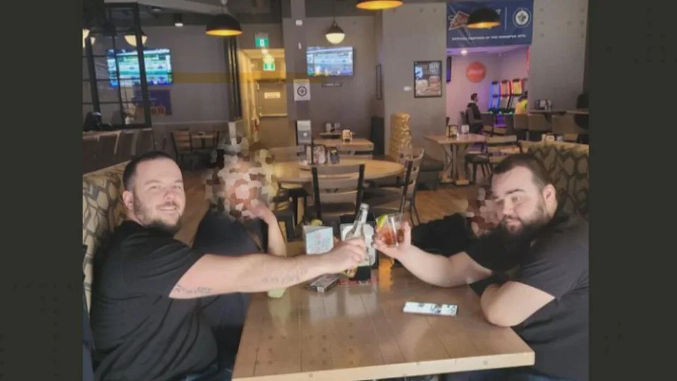 Tristan Mariash, 30, left, and David Frank Burling, 29, cheers in a photo posted to Mariash's Facebook page March 18 with the caption 'drinks with the family feels good to be out.' 
