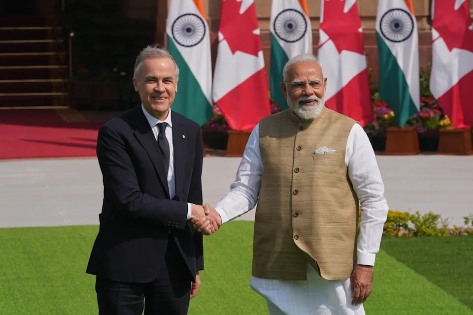 Indian Prime Minister Narendra Modi, right, shakes hands with his Canadian counterpart Mark Carney before their delegation level meeting in New Delhi, India, Monday, March 2, 2026. (AP Photo/Manish Swarup) (AP)