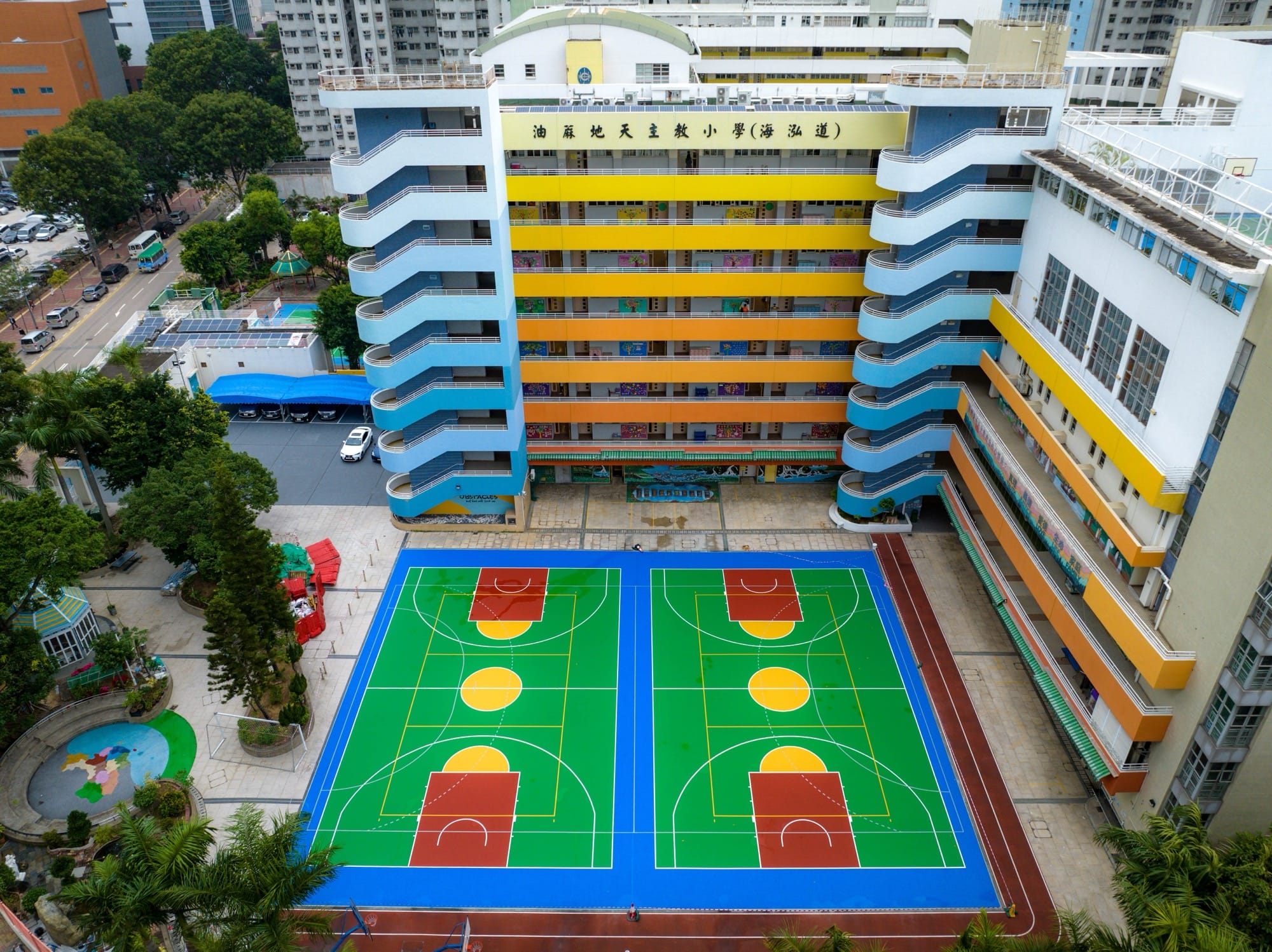 Colorful basketball courts amid tall buildings in Hong Kong