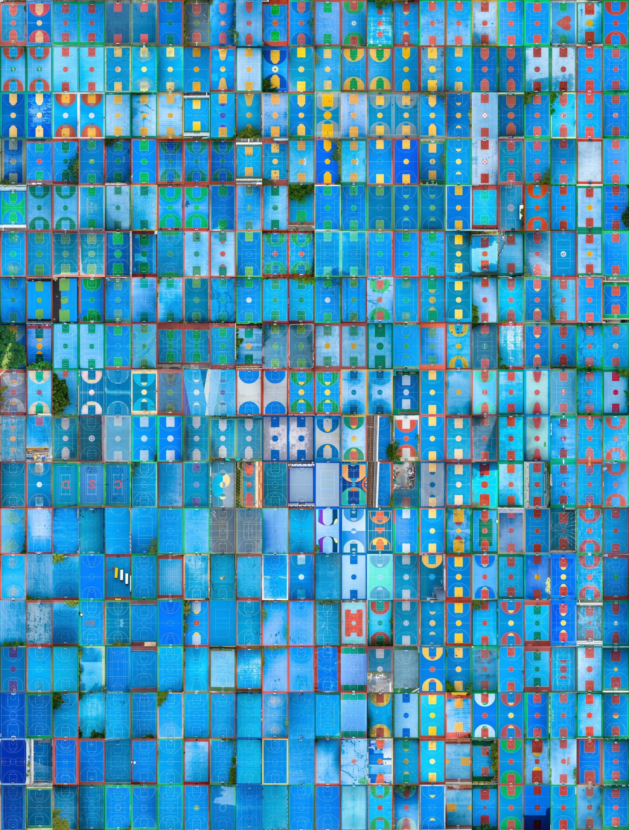 A colorful composite image of hundreds of predominantly blue-painted basketball courts, photographed from above, to create a huge grid