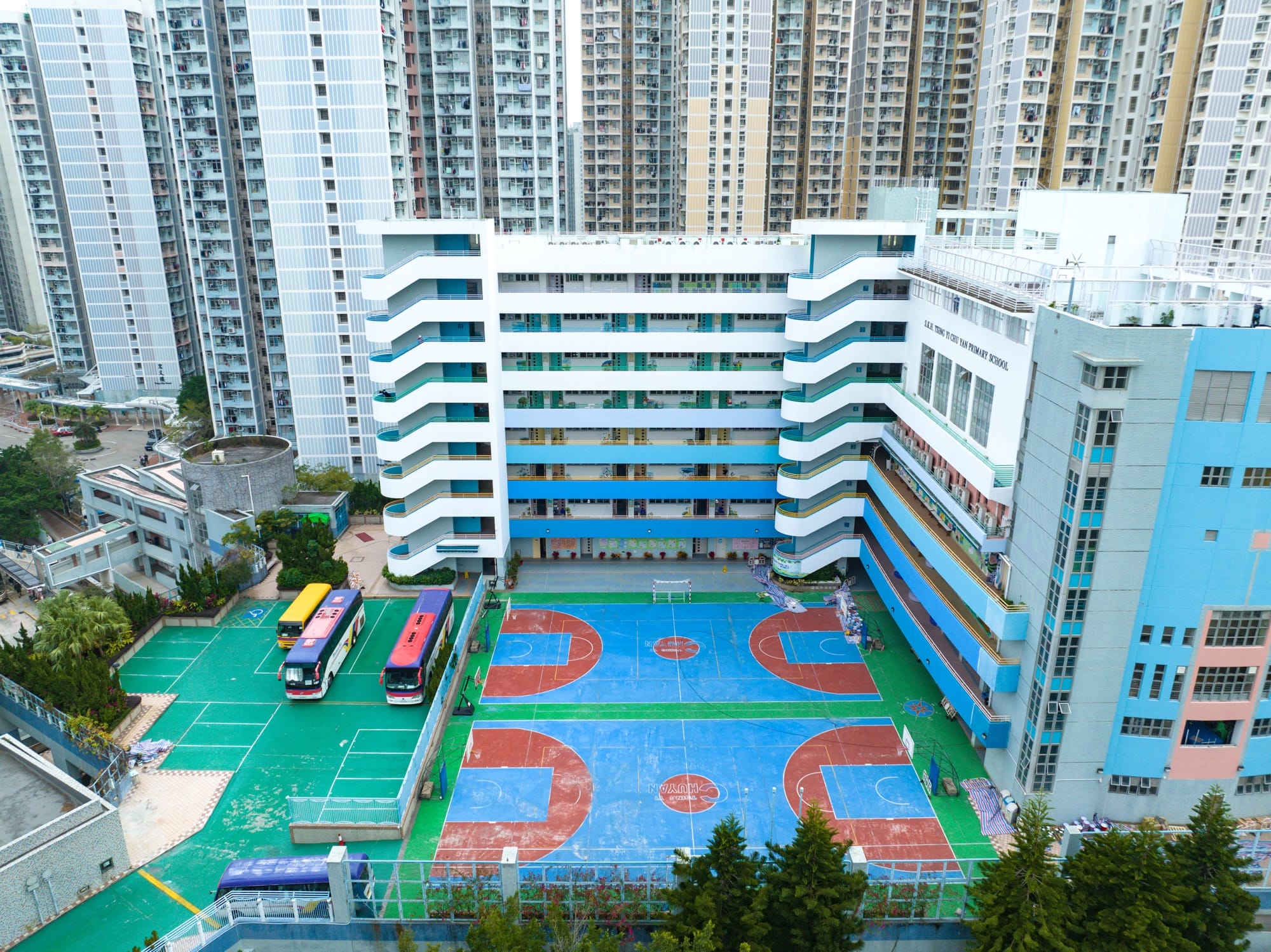 A colorful basketball court amid tall buildings in Hong Kong