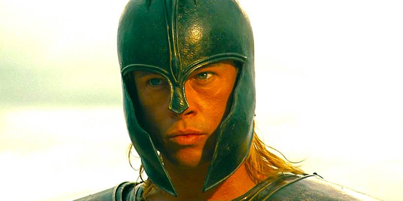 Brad Pitt as Achilles wearing a battle helmet and glaring menacingly in Troy
