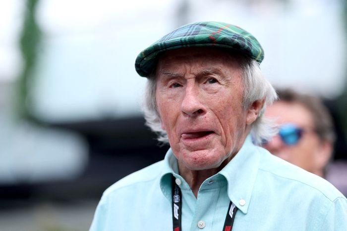 British former racing driver Jackie Stewart walks through the paddock  