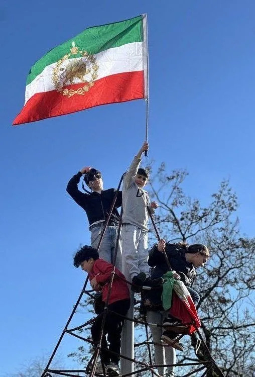  Children climbed a playground structure in Vancouver to raise the pre-revolution Iranian flag. Sarah Grochowski photo