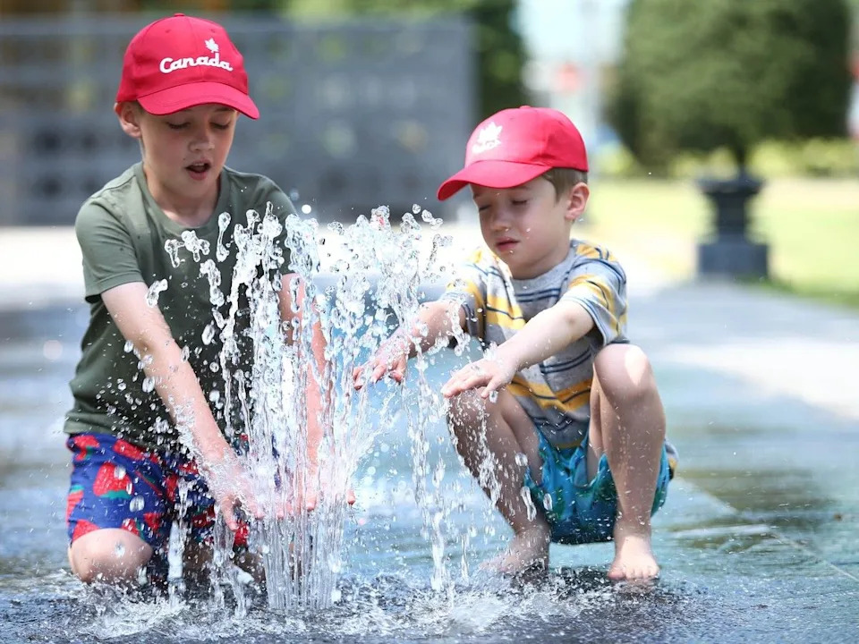  Brothers George (L), 9 yrs, and Teddy Green, 6 yrs) keep cool at some fountains at Central Memorial Park on Thursday, August 11, 2022.