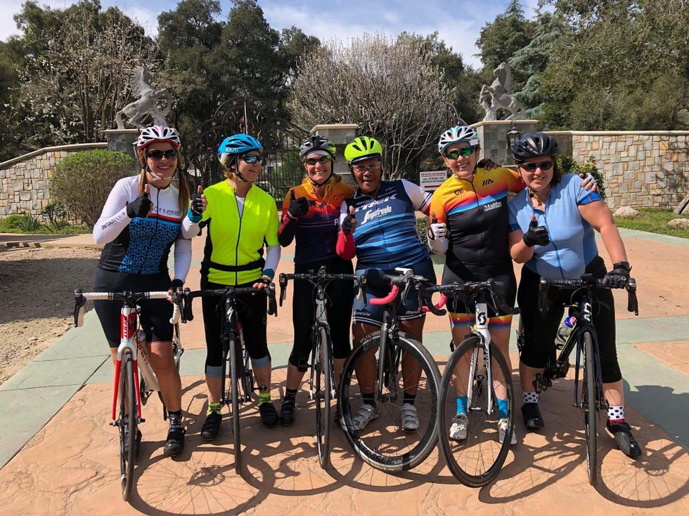 Group of cyclists posing outdoors
