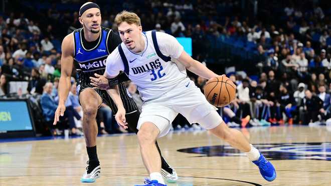 Cooper Flagg Mavericks Magic Cooper Flagg (#32) of the Dallas Mavericks drives to the basket against Jalen Suggs of the Orlando Magic in the first half of a game at Kia Center on March 5, 2026 in Orlando, Florida.