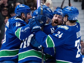 Vancouver Canucks' Filip Hronek (17) celebrates his late game-tying goal against the Nashville Predators with Drew O'Connor (18), Elias Pettersson (40), Zeev Buium (24) and Brock Boeser, back, during the third period at Rogers Arena on Thursday night.
