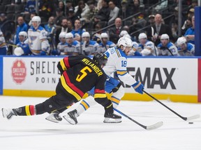 Vancouver Canucks' Tom Willander stumbles as St. Louis Blues' Robert Thomas skates past him with the puck on Saturday, March 21, 2026.
