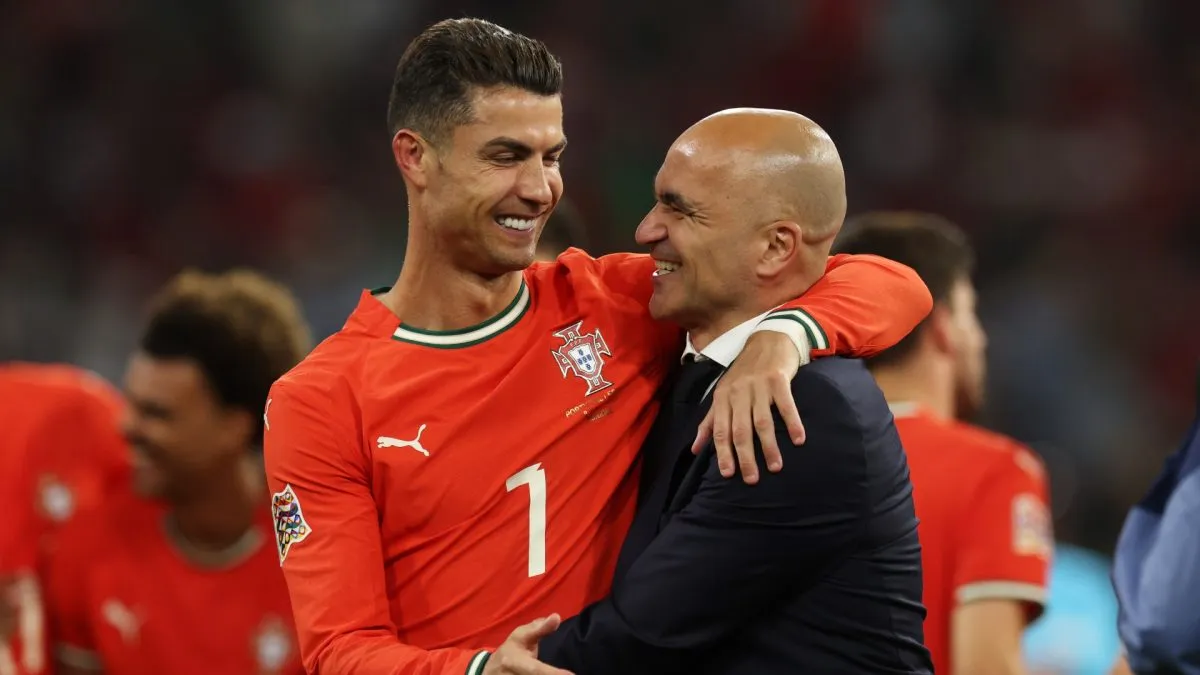 Cristiano Ronaldo of Portugal and Roberto Martinez, Manager of Portugal interact following victory in the UEFA Nations League 2025 final match between Portugal and Spain.