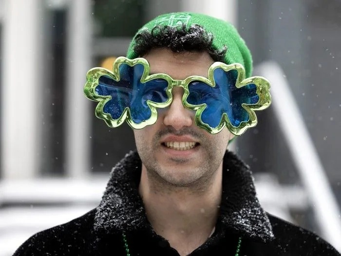  A spectator braves the steady snowfall to watch the St. Patrick’s Parade in Montreal on Sunday, March 22, 2026.