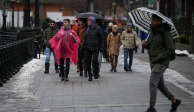 People walk along the seawall as rain falls in downtown Vancouver, Sunday, Dec. 25, 2022. THE CANADIAN PRESS/Darryl Dyck