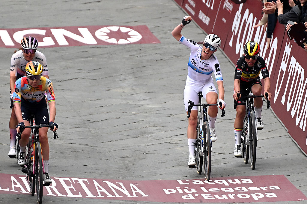 SIENA, ITALY - MARCH 07: (L-R) Anna van der Breggen of Netherlands and Team SD Worx - Protime, Demi Vollering of Netherlands and Team FDJ United - SUEZ and Justine Ghekiere of Belgium and Team AG Insurance - Soudal crosses the finish line during to the 12th Strade Bianche Donne 2026 a 133km one day race from Siena to Siena / #UCIWWT / on March 07, 2026 in Siena, Italy. (Photo by Luc Claessen/Getty Images)