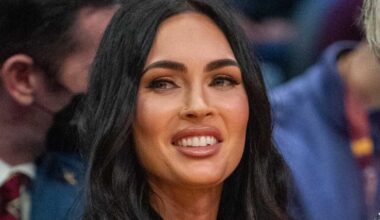 Megan Fox arches back in the sand wearing only pink floss for SI Swim