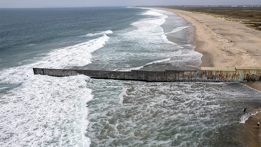 Large ocean waves rolling onto an empty beach.