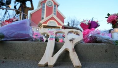 A piece of wood carved with TR with the names of victims on it is shown at a vigil for the victims of a mass shooting, in Tumbler Ridge, B.C., Friday, Feb. 13, 2026. THE CANADIAN PRESS/Christinne Muschi