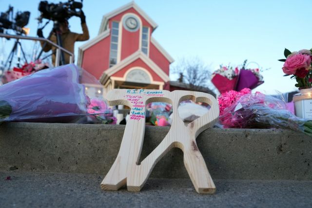 A piece of wood carved with TR with the names of victims on it is shown at a vigil for the victims of a mass shooting, in Tumbler Ridge, B.C., Friday, Feb. 13, 2026. THE CANADIAN PRESS/Christinne Muschi