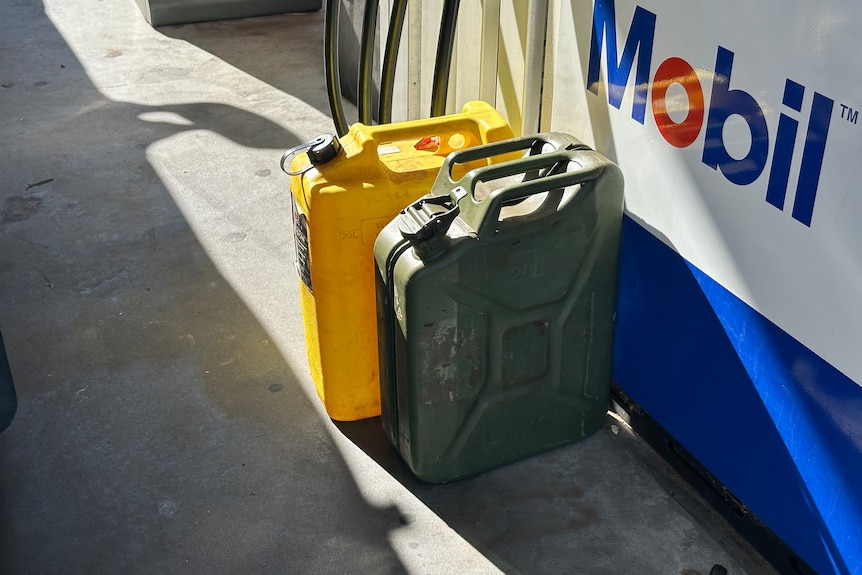 Jerry cans being filled up at a service station