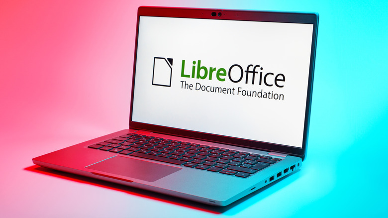 LibreOffice's logo displayed on a laptop on a pink and blue background