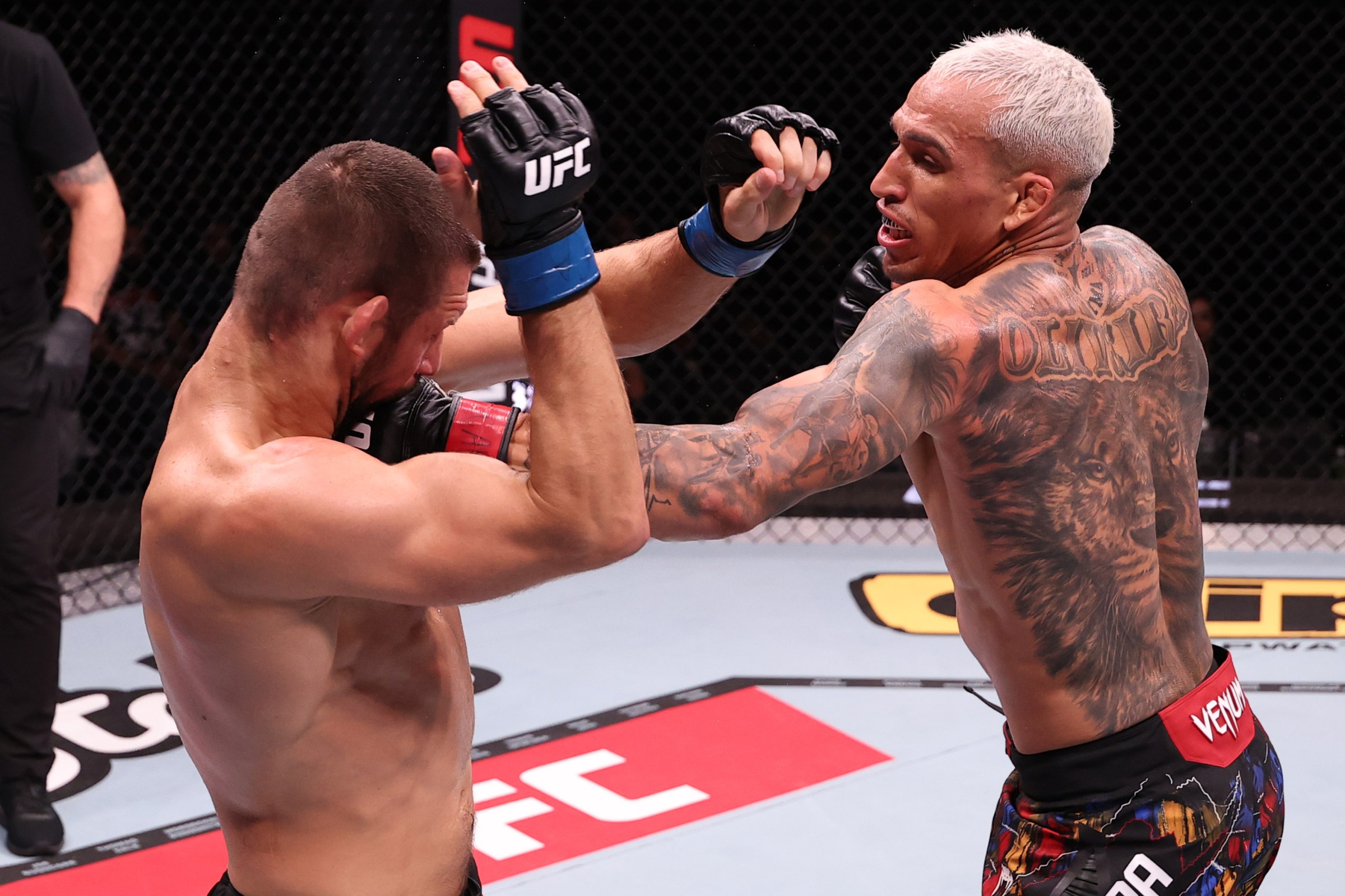 RIO DE JANEIRO, BRAZIL - OCTOBER 11: (R-L) Charles Oliveira of Brazil punches Mateusz Gamrot of Poland in a bantamweight fight during the UFC Fight Night event at Farmasi Arena on October 11, 2025 in Rio de Janeiro, Brazil. (Photo by Ed Mulholland/Zuffa LLC)