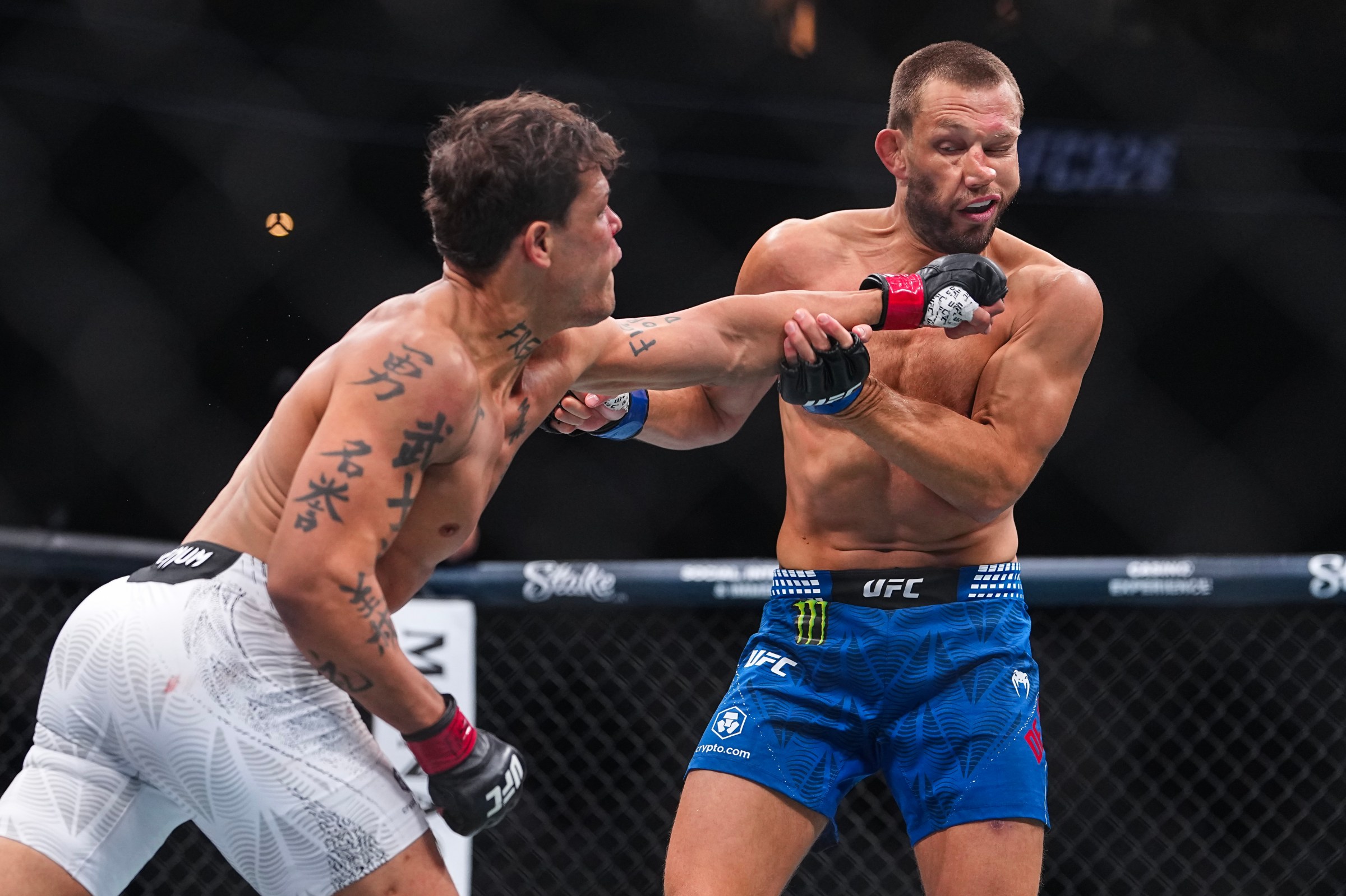 LAS VEGAS, NEVADA - MARCH 07: (L-R) Caio Borralho of Brazil strikes Reinier de Ridder of The Netherlands in a middleweight fight during the UFC 326 event at T-Mobile Arena on March 07, 2026 in Las Vegas, Nevada. (Photo by Chris Unger/Zuffa LLC)
