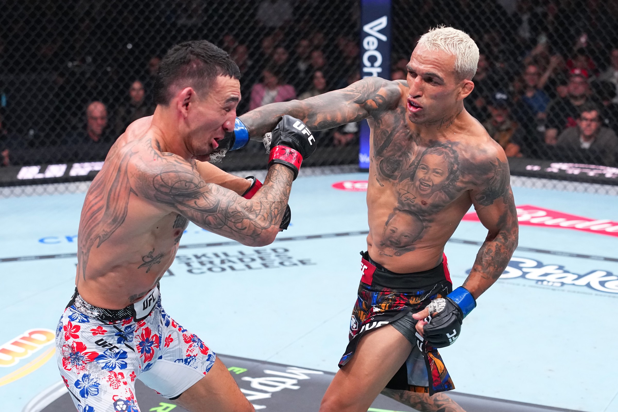LAS VEGAS, NEVADA - MARCH 07: (R-L) Charles Oliveira of Brazil strikes Max Holloway in the BMF Championship fight during the UFC 326 event at T-Mobile Arena on March 07, 2026 in Las Vegas, Nevada. (Photo by Jeff Bottari/Zuffa LLC)