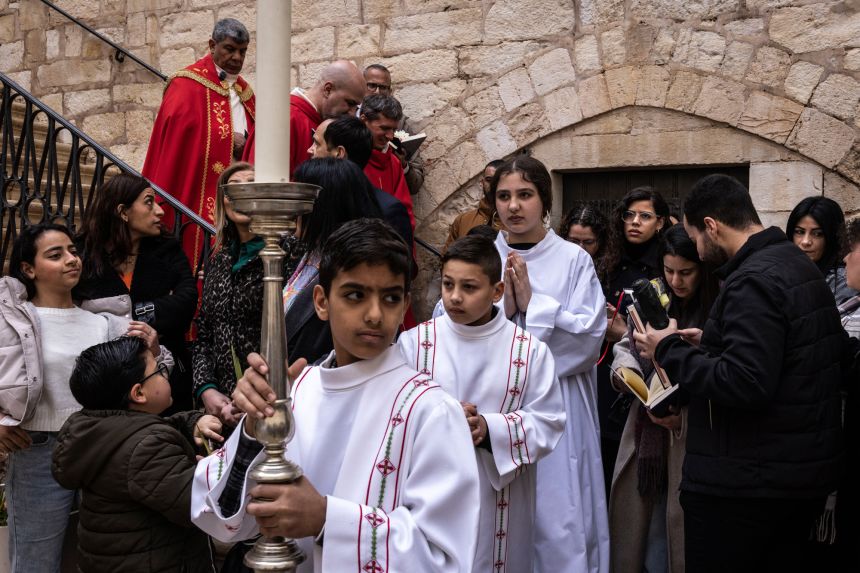Altar servers start the Palm Sunday Mass Procession, commemorating Jesus Christ's entry into Jerusalem, at the Catholic Franciscan Monastery of Saint Saviour in the old city of Jerusalem on March 29.