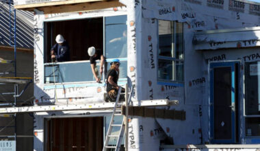 Workers on a home construction job site in Victoria.