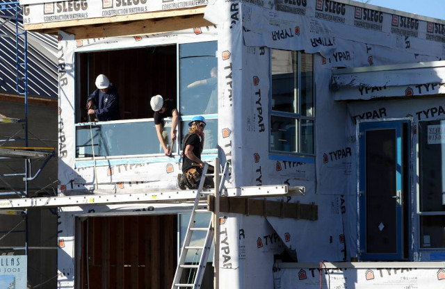 Workers on a home construction job site in Victoria. | Bruce Stotesbury / Times Colonist