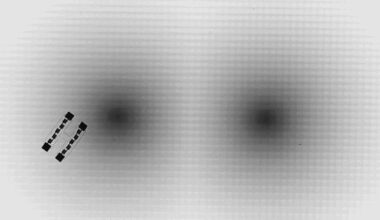 Microscopic swimming robots navigate 'artificial space-time' mazes using Einstein's relativity