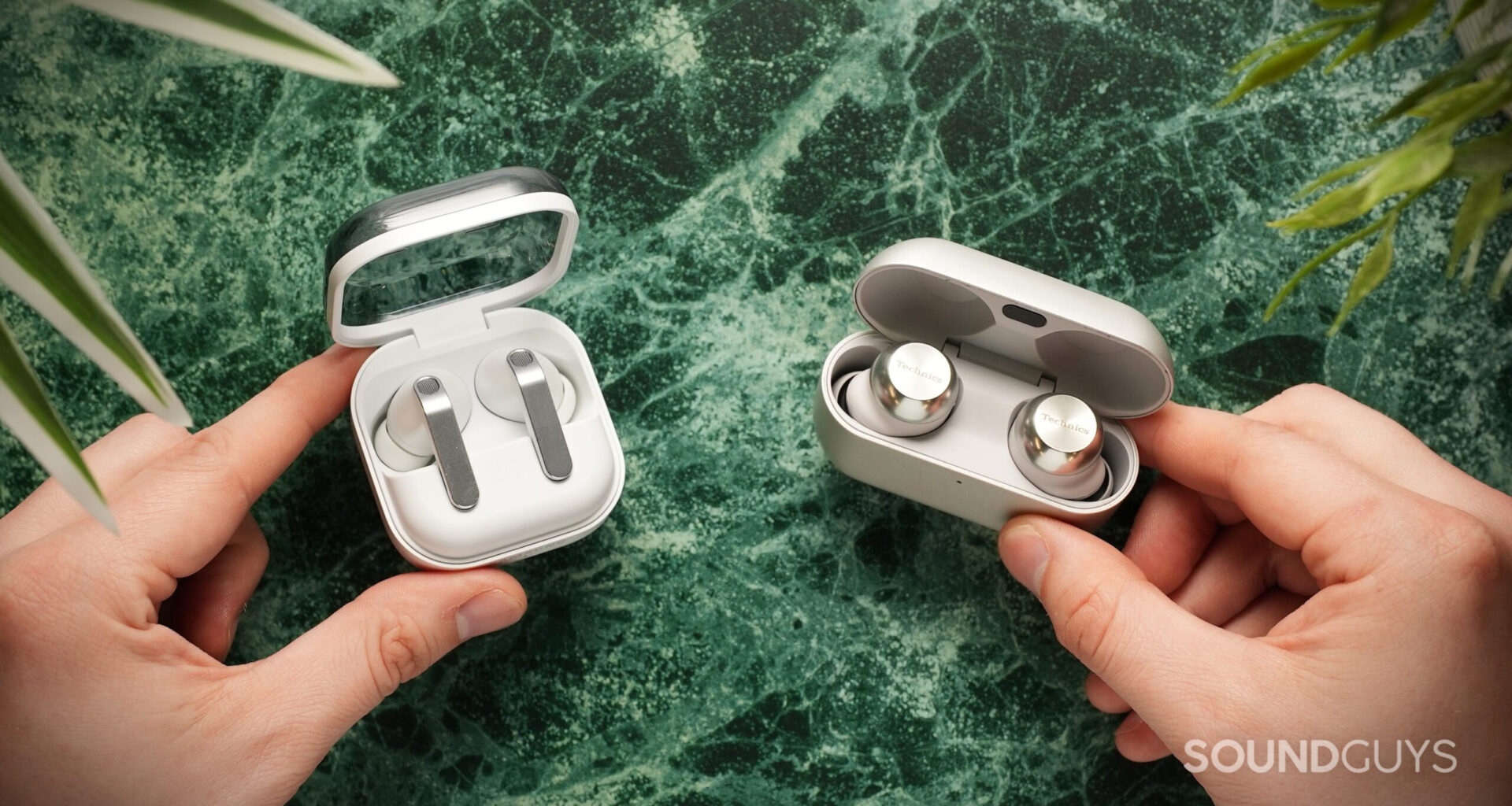 hands holding the samsung galaxy buds 4 pro vs technics az1000