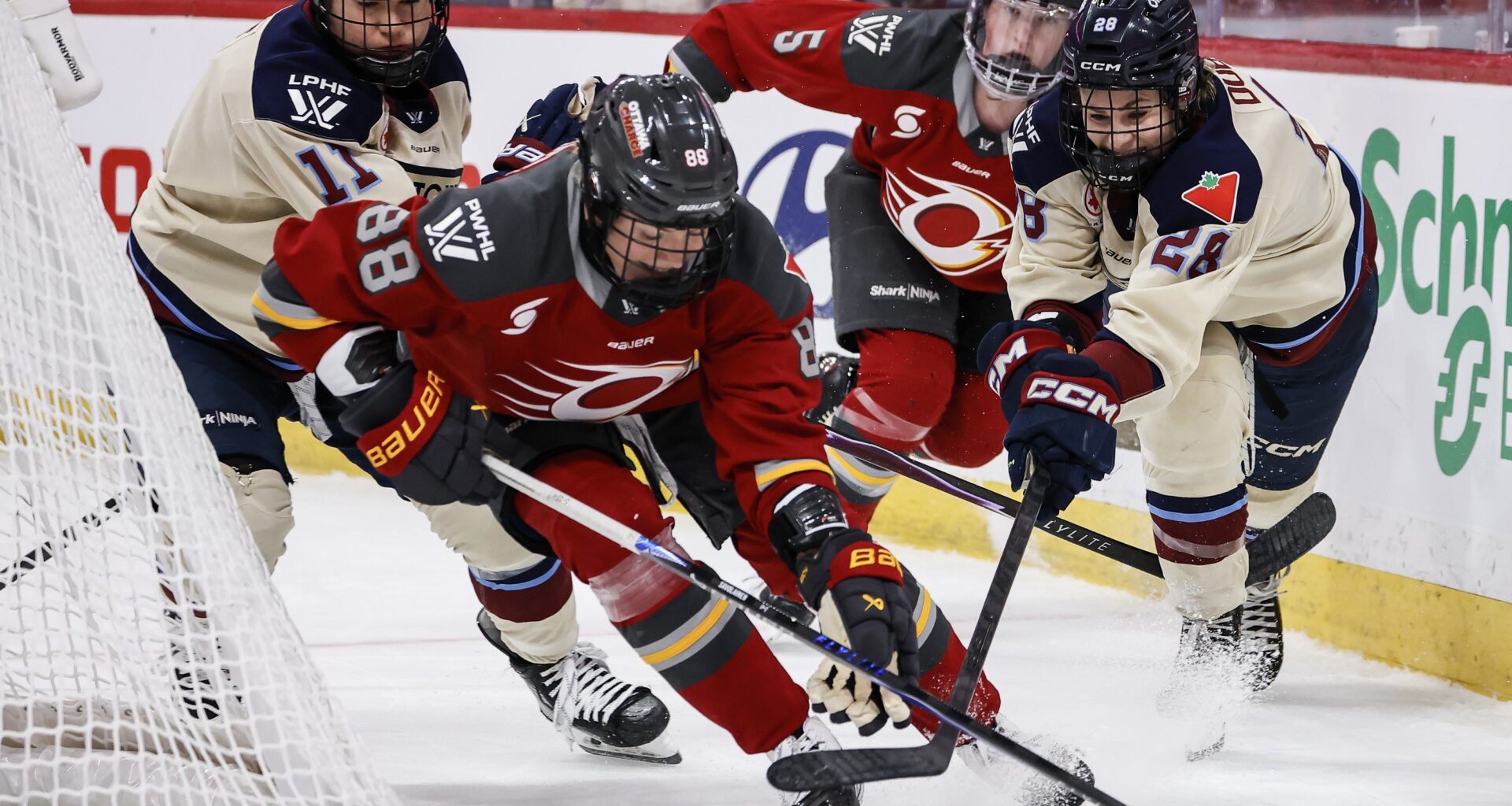 Hockey player races after an opponent behind the net.