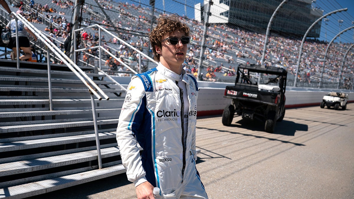 NTT IndyCar Series driver David Malukas walking toward his car at Nashville Superspeedway