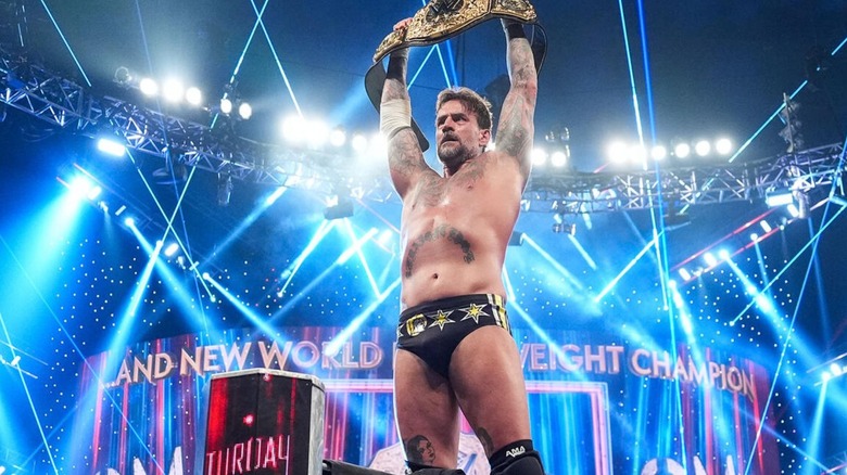 CM Punk holds up the World Heavyweight Championship in the corner after his victory at Saturday Night's Main Event.