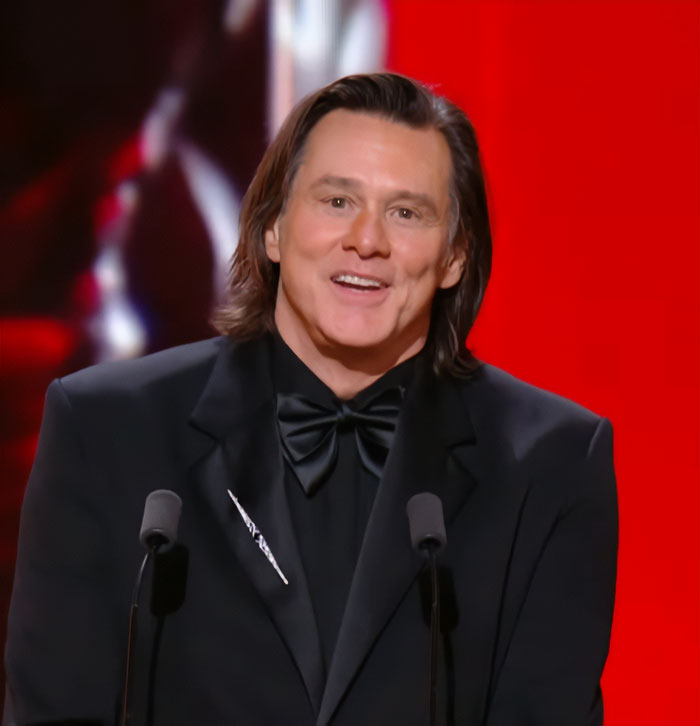 Jim Carrey speaking at an event in a black tuxedo, as drag queen theories about a mask he wore spark new interest. Jim Carrey speaking at an event in a black tuxedo, as drag queen theories about a mask he wore spark new interest.