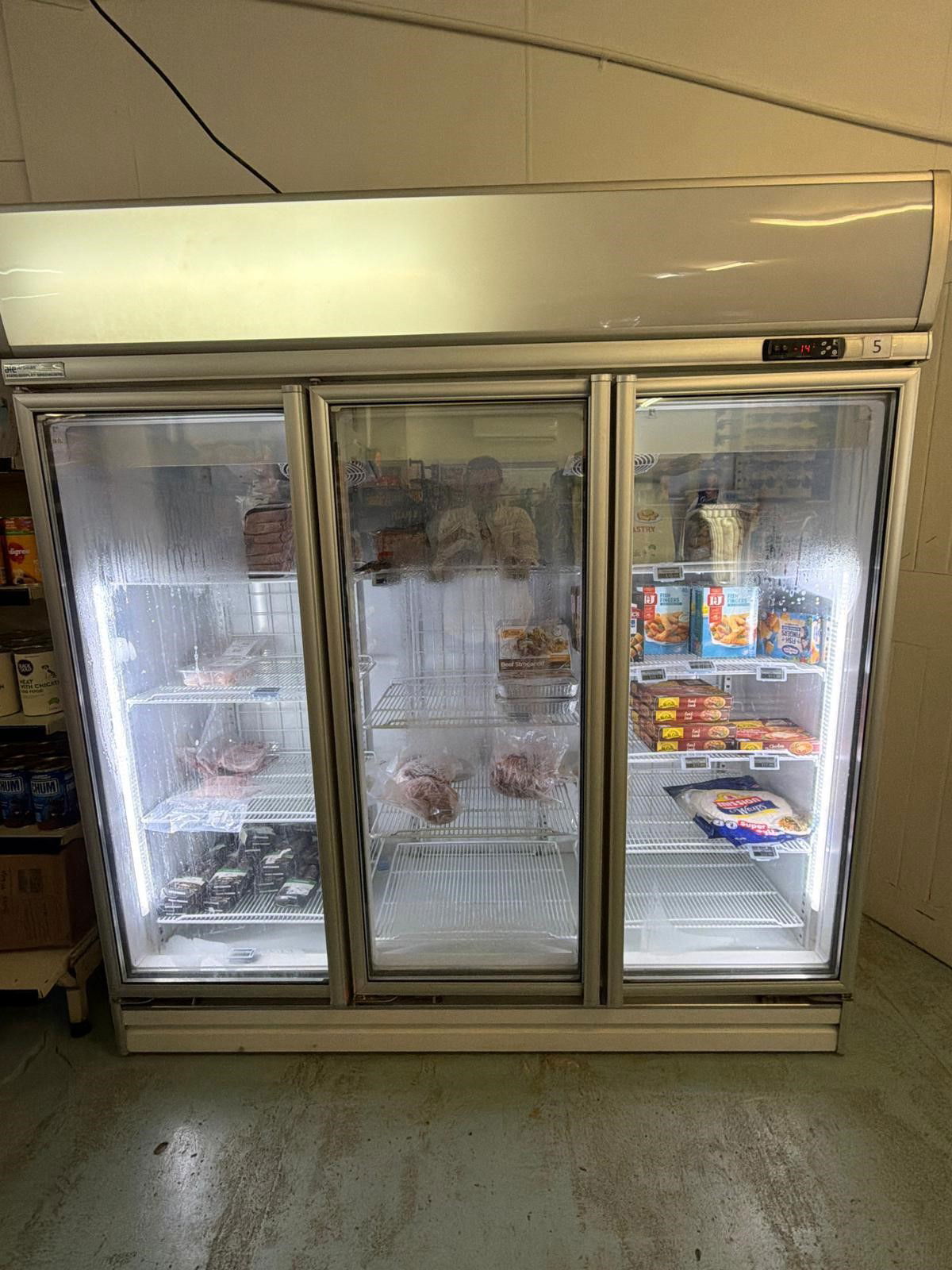 A freezer with a few remaining food items