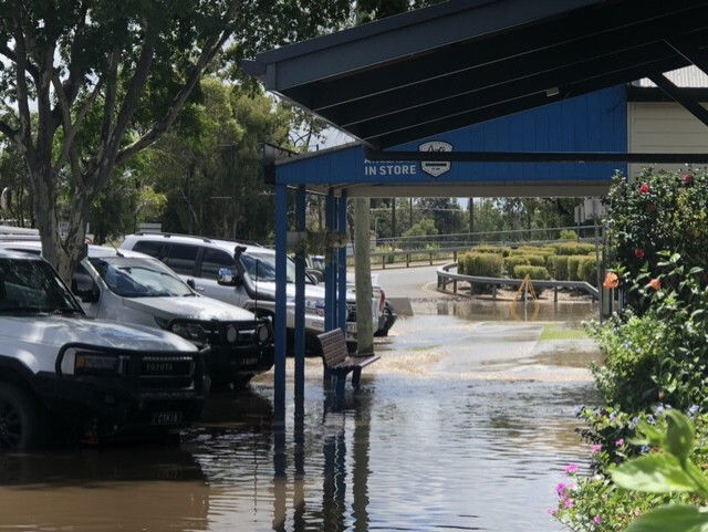 Flood water on a street rising above the tyres of four wheel drives. 