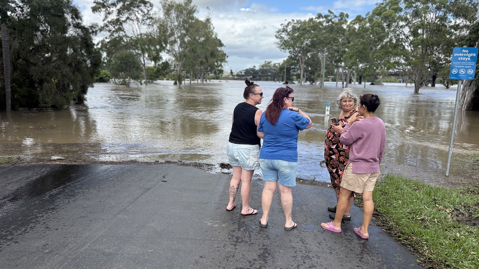 A group of women chat near the river