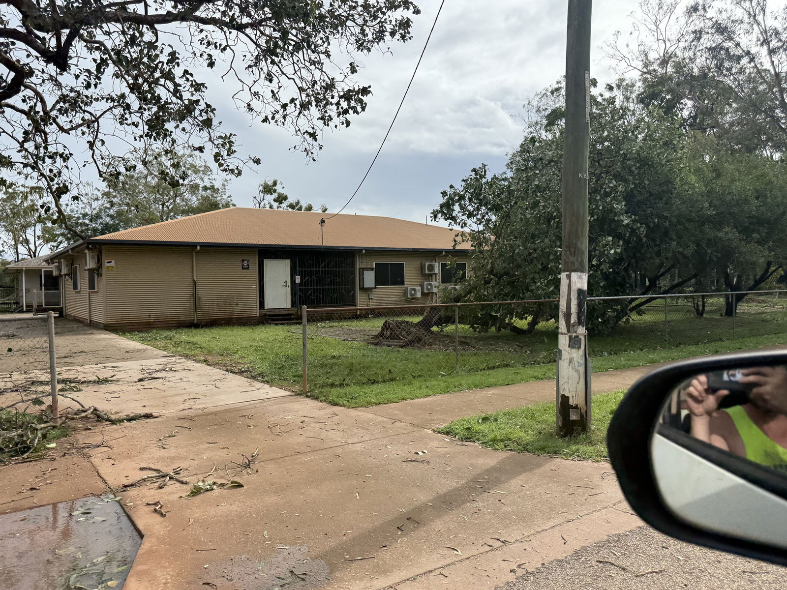 A fallen tree in front of a house. 