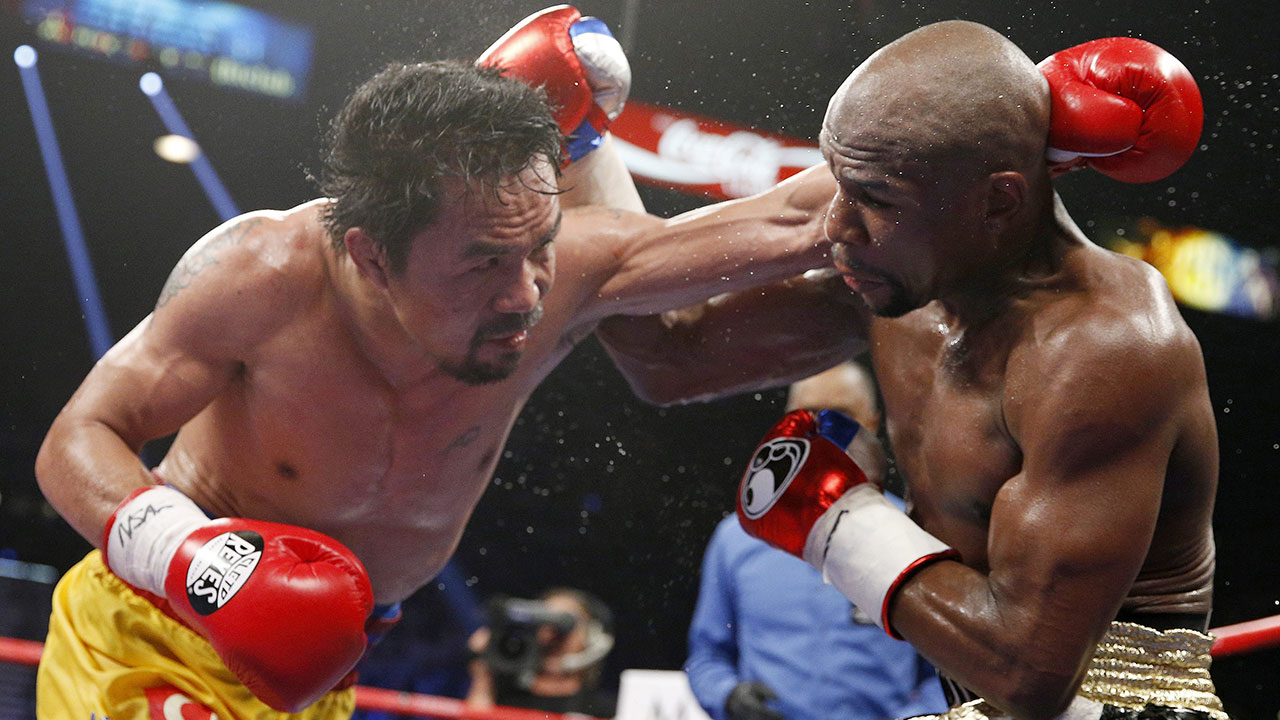 Manny Pacquaio (left), pictured here during a boxing match against Floyd Mayweather Jr. in 2015. (John Locher/AP)