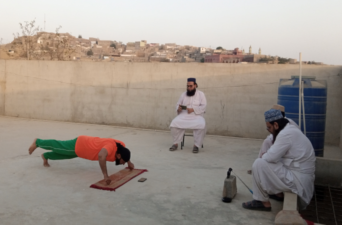 Muhammad performing push-ups at his local village