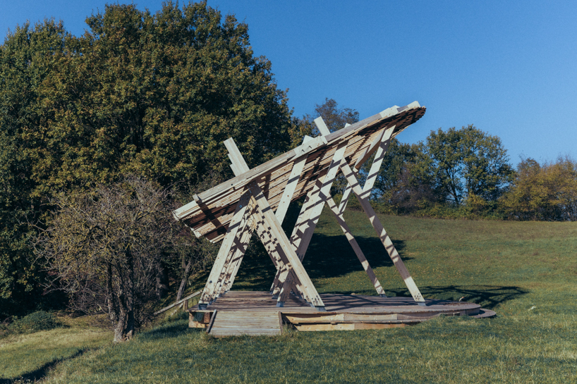 palcosole by grriz raises a half sun of timber above a historic park to gather community and light 4